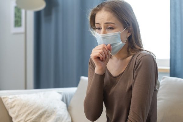 woman with mask staying quarantine coughing 23 2148480542 600x400